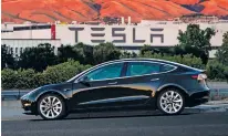  ?? COURTESY OF TESLA MOTORS VIA AP ?? The electric car company’s newest vehicle, the Model 3, which went to its first 30 customers Friday, is half the cost of previous models at $35,000.