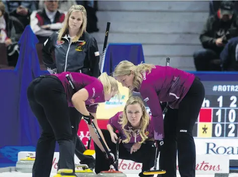  ?? ADRIAN WYLD/THE CANADIAN PRESS ?? Jennifer Jones, left, lost Wednesday to Chelsea Carey, middle, and her team at the Roar of the Rings in Ottawa.