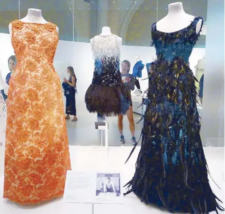  ??  ?? Evening dress in lace, ra a embroidery and coral and glass beading (1964); and evening dress in silk ta eta with feathers, braids and beads (1960), both by Hubert de Givenchy.