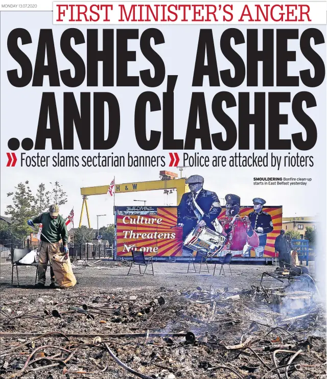  ??  ?? SMOULDERIN­G Bonfire clean-up starts in East Belfast yesterday