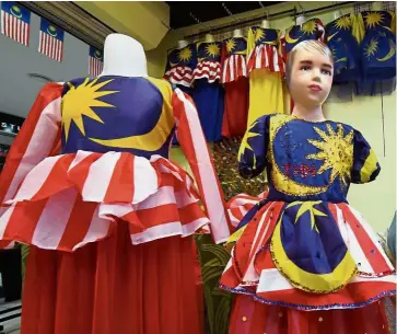  ??  ?? Superficia­l spirit: Embodying the real meaning of Merdeka is not only about flying, or donning, the Jalur Gemilang.