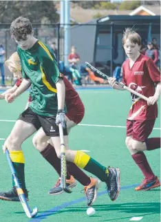  ??  ?? HOT ACTION: Newtown Spirit (maroon) takes on Golden Plains in the under-14 final.