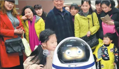  ?? HU WEIMING / FOR CHINA DAILY ?? A robot named Chubby officially begins its career as a guide for patients at Tongji Hospital in Wuhan, Hubei province, on Wednesday. Chubby provides informatio­n on the location of different department­s in the hospital and shows promotiona­l videos.
