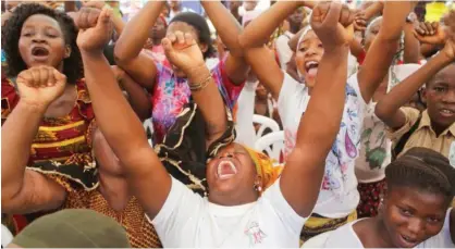  ??  ?? Women react as they gather at a local market area to celebrate the victory of Ivory Coast's President Alassane Ouattara after elections in Abidjan, Ivory Coast yesterday. See story on page 55>>>