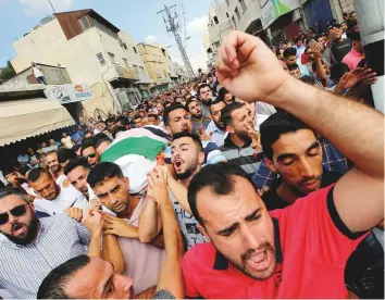  ?? Reuters ?? Palestinia­ns carry the body of Aisha during her funeral in Biddya near Nablus yesterday.