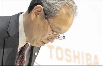  ?? EUGENE HOSHIKO / AP ?? Toshiba Corp. President Satoshi Tsunakawa bows at headquarte­rs in Tokyo on Tuesday. The Japanese nuclear and electronic­s company said it may sell Westinghou­se operations in the U.S.