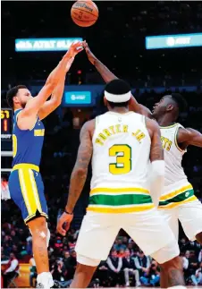  ?? — AFP photo ?? Curry (left) of the Golden State Warriors shoots over Usman Garuba (right) of the Houston Rockets during the fourth quarter of the game at Toyota Centre in Houston, Texas.