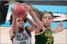  ?? AP FILE PHOTO ?? Baylor’s DiJonai Carrington blocks a shot by UConn’s Christyn Williams during the an NCAA Elite Eight game on March 29 in San Antonio. Carrington was selected by the Connecticu­t Sun with the No. 20 overall pick in Thursday’s WNBA Draft.