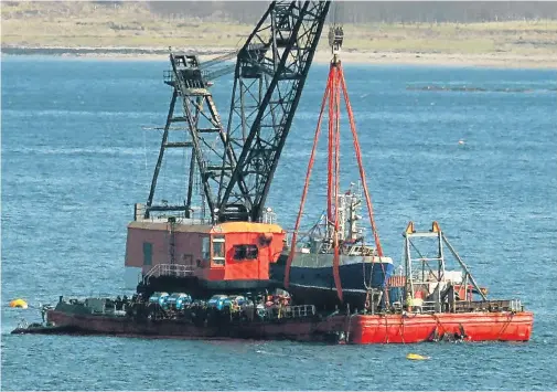  ??  ?? RAISED FROM DEEP: Prawn trawler Nancy Glen was lifted from 460ft onto a barge in Loch Fyne yesterday after an all-night salvage operation