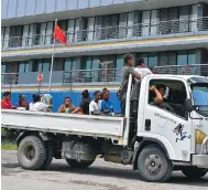  ?? Photo: AFP ?? Traffic makes its way past China’s embassy in Honiara yesterday afternoon, in advance of the Solomon Islands’ election.