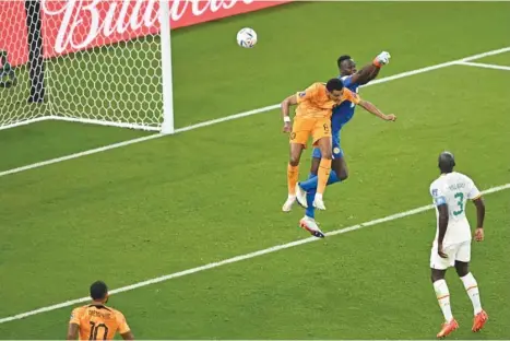  ?? (AFP) ?? Netherland­s’ forward Cody Gakpo (centre) scores even as Senegal’s goalkeeper Edouard Mendy attempts to stop him in vain during the FIFA World Cup Qatar 2022 at the Al Thumama Stadium in Doha yesterday.