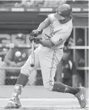  ??  ?? Jays outfielder Curtis Grandson belts a solo home run against the White Sox during the first inning in Chicago.