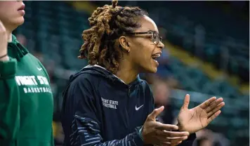  ?? WRIGHT STATE ATHLETICS PHOTO ?? Makira “Bunny” Webster, unable to play anymore due to concussion­s, cheers on her Wright State women’s basketball teammates during Wednesday night’s game against Robert Morris at the Nutter Center.