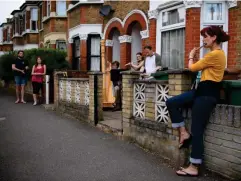  ??  ?? Neighbours perform music for residents of Walthamsto­w during a Clap for Carers Thursday in May (Getty)
