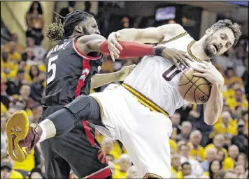  ?? TONY DEJAK / ASSOCIATED PRESS ?? The Raptors’ DeMarre Carroll (left) and the Cavaliers’ Kevin Love tangle in Game 1. Love was the Cavs’ third-leading scorer with 18 points.