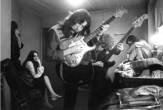  ??  ?? Rory tuning up, with difficulty, in a crowded backstage area with Gerry McAvoy in the early years of his solo career. Gerry would remain a constant in the lineup of Rory’s bands, even while others came and went
