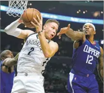  ?? Jae C. Hong Associated Press ?? CLIPPERS’ ERIC BLEDSOE, right, and Reggie Jackson combined for 46 points Saturday to outscore the Brooklyn Nets by 14.