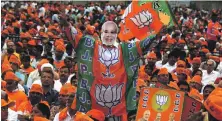  ?? EPA ?? A Bharatiya Janata Party supporter wear a mask of Indian Prime Minister Narendra Modi at a rally in Bangalore