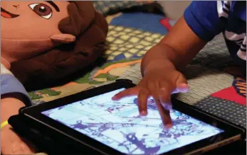  ?? PICTURE: AP ?? Children are spending far more time looking at screens than ever before.