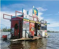  ?? SOUTH FLORIDA SUN SENTINEL
MIKE STOCKER/ ?? Jay’s Sandbar Floating BBQ serves pork nachos and alligator bites to hungry boaters and bikini-wearing partiers on the sandbar in October 2020 in Fort Lauderdale. Owner Jay Lycke is vowing to have wreckage of
the now sunken restaraunt hauled away this weekend.