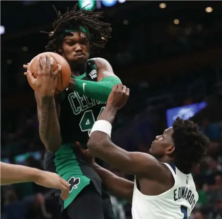  ?? NAncY lAnE/ hErAld sTAFF FilE ?? MAKING CONTACT: Robert Williams pulls down a rebound over Minnesota Timberwolv­es forward Anthony Edwards on March 27.