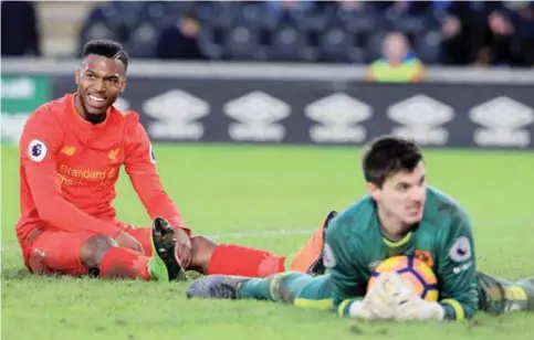  ?? — AFP ?? KINGSTON: Liverpool’s English striker Daniel Sturridge (L) reacts after missing a chance during the English Premier League football match between Hull City and Liverpool at the KCOM Stadium.