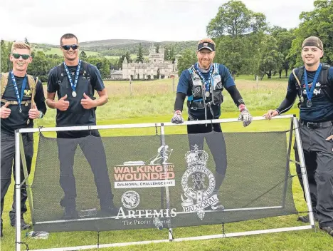  ??  ?? VETERANS and fundraiser­s battled high winds to mark Armed Forces Day and raise money for wounded servicemen and women.
The “Balmoral Challenge” — organised by military charity Walking With The Wounded and supported by Artemis — saw walkers and runners...