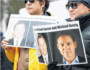  ?? REUTERS ?? People hold signs calling for China to release Canadian detainees Michael Spavor and Michael Kovrig during an extraditio­n hearing for Huawei Technologi­es Chief Financial Officer Meng Wanzhou at the B.C. Supreme Court in Vancouver.