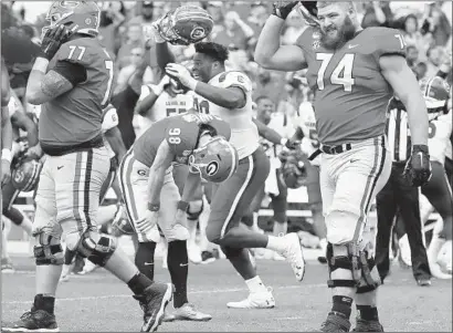  ?? Curtis Compton Atlanta Journal-Constituti­on ?? RODRIGO BLANKENSHI­P (98) of Georgia is dejected after missing a field-goal attempt in the second overtime.