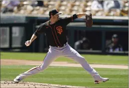  ?? ROSS D. FRANKLIN — THE ASSOCIATED PRESS ?? Giants starting pitcher Kevin Gausman winds up during the first inning of the team’s spring training game against the Chicago White Sox on Monday in Phoenix.