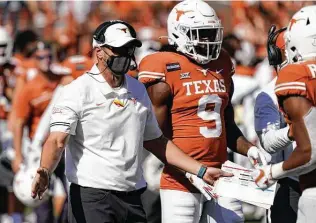  ?? Chuck Burton / Associated Press ?? Texas coach Tom Herman is on the hot seat after another disappoint­ing season. And it only got hotter amid athletic director Chris Del Conte’s failed pursuit of Urban Meyer.