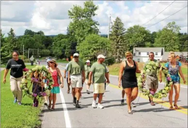  ?? CHARLES PRITCHARD — ONEIDA DAILY DISPATCH ?? Wreaths are carried from the Gerrit Smith Estate National Historic Landmark to the Peterboro Cemetary for Emancipati­on Day on Saturday, Aug. 4, 2018.