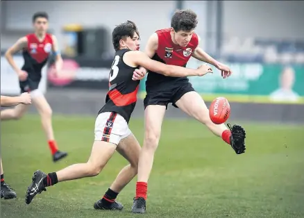  ??  ?? Kyabram’s Blake Mcauliffe can’t stop Shepp United’s Brodie Telford from getting hjis kick away. Picture: Megan Fisher.
