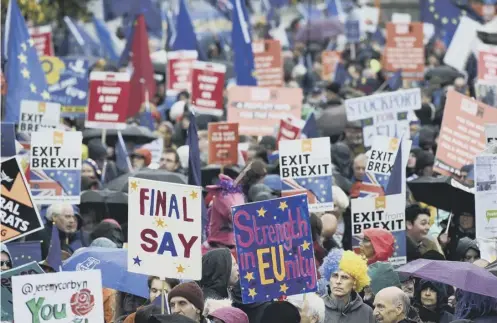  ??  ?? 0 Protesters march to demand a People’s Vote on Brexit. The Scottish Parliament has backed another poll