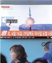  ?? AHN-YOUNG-JOON/ASSOCIATED PRESS ?? People at the Seoul Railway Station in Seoul, South Korea, watch a TV news program on Sunday showing a file image of a missile launch conducted by North Korea.