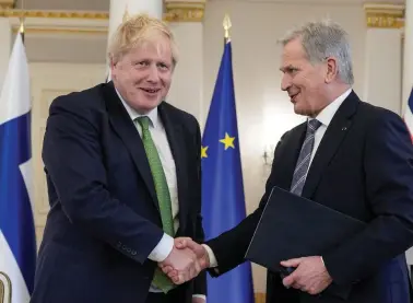  ?? REUTERS ?? British Prime Minister Boris Johnson and Finnish President Sauli Niinisto shake hands, after signing a declaratio­n between the UK and Finland to deepen their defence and security co-operation, amid Russia’s invasion of Ukraine, at the Presidenti­al Palace, in Helsinki, Finland, on Wednesday.