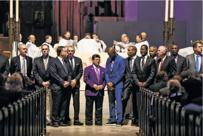  ?? Photos by Gabrielle Lurie / The Chronicle ?? Former 49ers owner Eddie DeBartolo (center) stands with former players at Dwight Clark’s memorial service at Grace Cathedral. Clark, a former 49ers wide receiver, died from complicati­ons related to ALS on June 4.