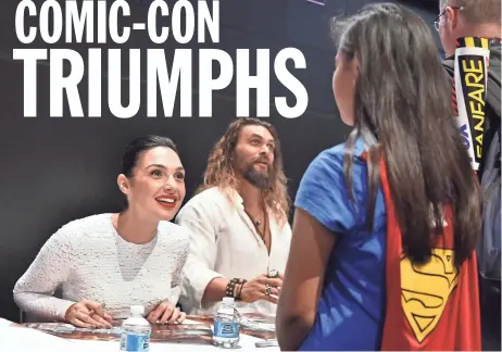  ?? GETTY IMAGES ?? Actors Gal Gadot (left) and Jason Momoa greet fans during the “Justice League” autograph signing at Comic-Con Internatio­nal 2017 at the San Diego Convention Center on Saturday.