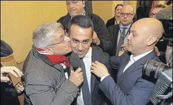  ?? AP ?? Five Star Movement leader Luigi Di Maio (centre) is kissed by a journalist as he arrives for a press conference. The antiestabl­ishment movement emerged as the single largest party in the polls.