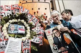  ?? ESTEBAN FELIX/AP ?? Elena Aranada, who worked in the administra­tion of Chile’s late President Salvador Allende, visits a memorial Tuesday in Santiago. On Sept. 11, 1973, Allende was killed in a coup that began Gen. Augusto Pinochet’s 17-year dictatorsh­ip.