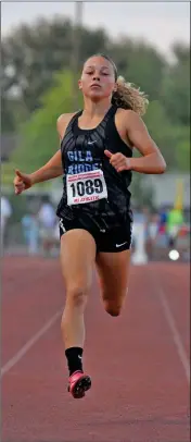  ?? PHOTO BY GRADY GARRETT/YUMA SUN ?? GILA RIDGE’S MIA CORNERS crosses the finish line during the Division II girls 200-meter dash finals Saturday at the AIA Track and Field State Championsh­ips at Mesa Community College. Corners placed sixth in the event in a personal-best 25.30.