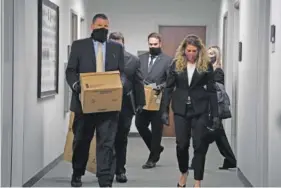  ?? ASSOCIATED PRESS PHOTO ?? FBI agents leave with items from state Rep. Kent Calfee’s office heading to Rep. Glen Casada’s office at the Cordell Hull State Office Building in Nashville on Jan. 8.