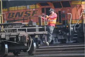  ?? LM OTERO/THE ASSOCIATED PRESS, FILE ?? A worker rides a rail car at a BNSF rail crossing in Saginaw, Texas, on Wednesday, Sept. 14, 2022.