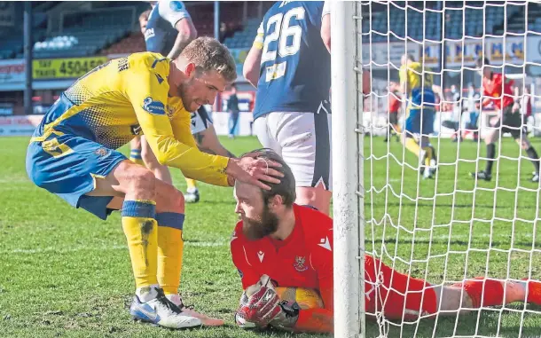  ??  ?? SAFE HANDS: Zander Clark is congratula­ted by David Wotherspoo­n after saving a penalty in Saturday’s Scottish Cup win at Dens.