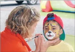  ??  ?? Cheetah: Six-year-old Jaydyn Robinson getting his face painted by Pancake House owner Aukje de Wilde.
