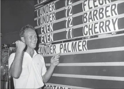  ?? FILE — THE ASSOCIATED PRESS PHOTOS ?? This file photo shows Arnold Palmer pointing to his name on the press tent scoreboard showing his four-under-par total, for 72 holes, during the National Open golf tournament at the Cherry Hills Country Club in Denver, Colo. Palmer, who made golf...