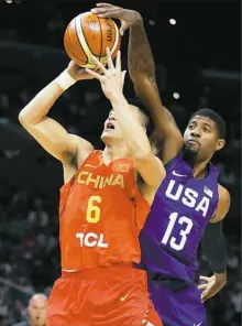  ?? Sean M. Haffey/Getty Images ?? Paul George of the United States blocks a shot against China’s Guo Ailun during an exhibition game Sunday in Los Angeles.
