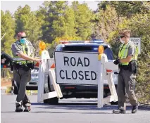  ?? MATT YORK/ASSOCIATED PRESS ?? U.S. Park Rangers close the entrance to the Grand Canyon in Grand Canyon, Arizona. The Grand Canyon is expanding access to its more popular South Rim entrance and planning to let visitors in around the clock next month after it shuttered temporaril­y over coronaviru­s concerns.