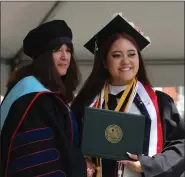  ?? ?? Interim Provost and Vice President for Academic Affairs Catherine Canney presents diploma to Genesis Toledo at Fitchburg State University’s Commenceme­nt.