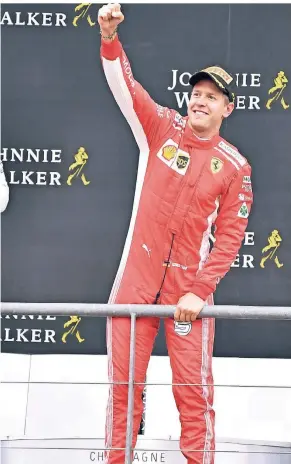  ?? FOTO: AP ?? Der deutsche Ferrari-Pilot Sebastian Vettel jubelt nach seinem Triumph bei der Siegerehru­ng in Spa.